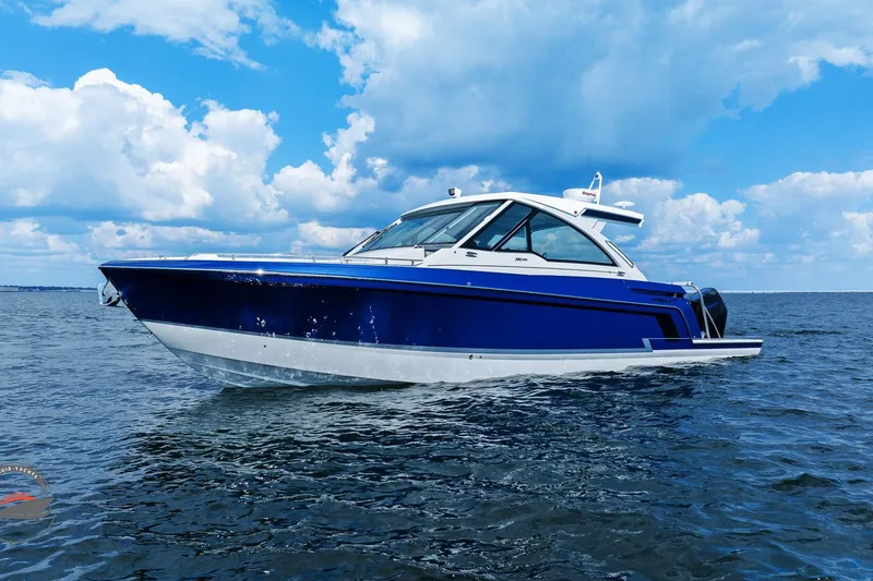The Image of 2025 Formula 380 Super Sport Crossover OB boat on open water under blue sky. - 1
