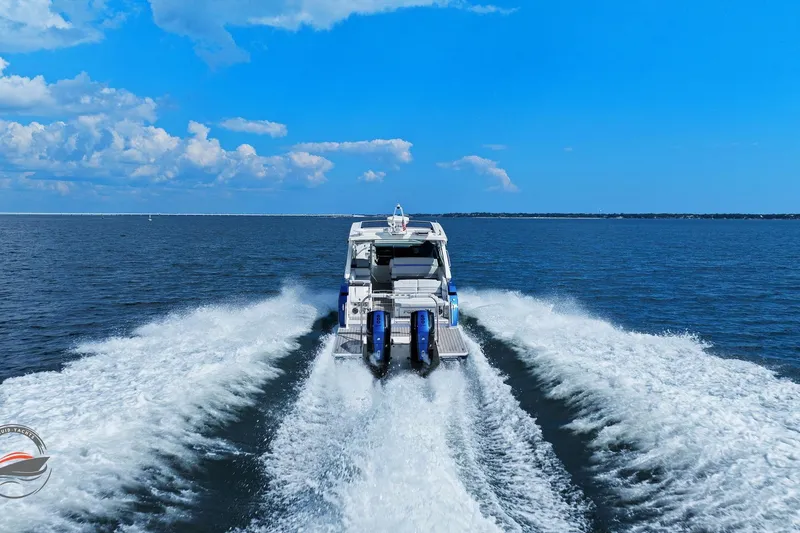 Slide: The Image of 2025 Formula 380 Super Sport Crossover OB cruising on open water, leaving a wake. - 11