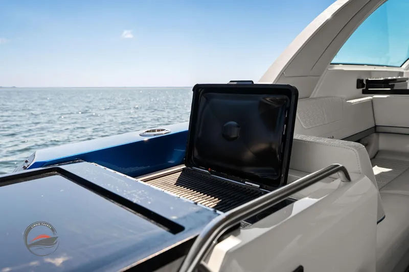 Slide: The Image of 2025 Formula 380 Super Sport Crossover OB with onboard grill, ocean view. - 24