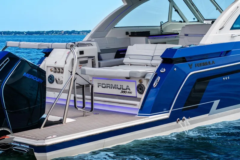 Slide: The Image of 2025 Formula 380 Super Sport Crossover OB luxury boat on water, featuring sleek design and Mercury engine. - 5