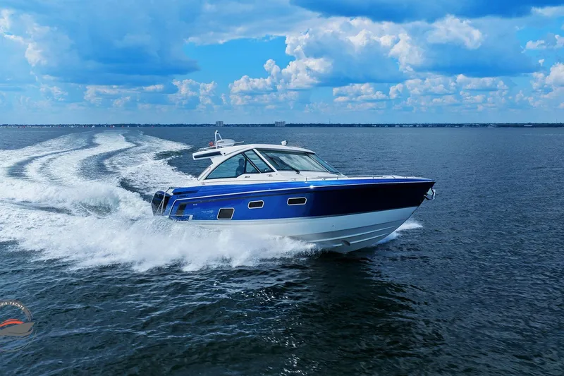 Slide: The Image of 2025 Formula 380 Super Sport Crossover OB cruising on open water under blue skies. - 8