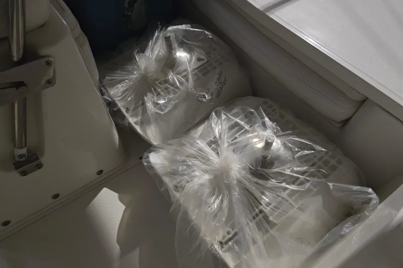 Slide: The Image of 2008 Boston Whaler 180 Dauntless interior with plastic-covered equipment. - 10