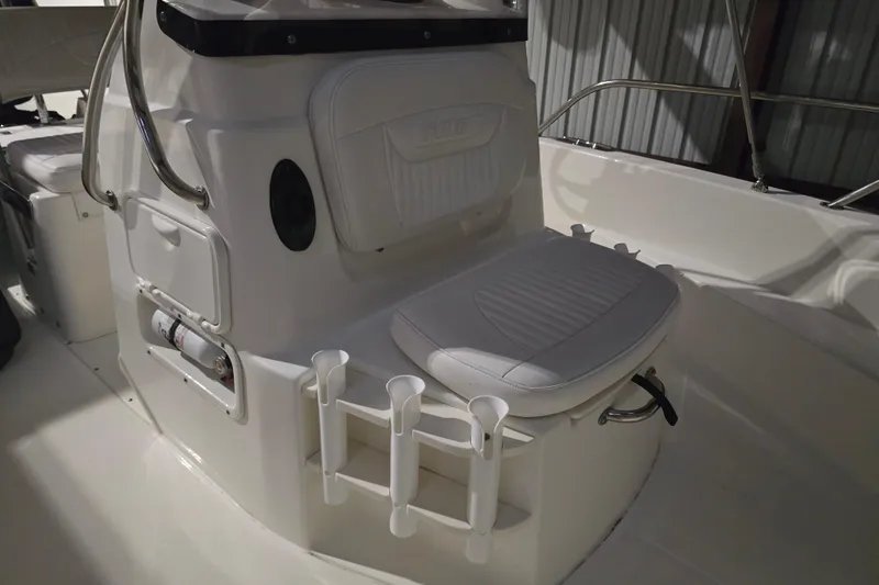 Slide: The Image of 2008 Boston Whaler 180 Dauntless boat interior with cushioned seating and rod holders. - 6