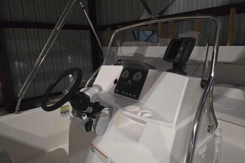Slide: The Image of 2008 Boston Whaler 180 Dauntless boat console with steering wheel and navigation controls. - 7