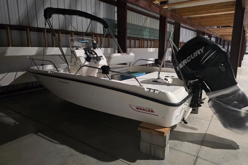 Slide: The Image of 2008 Boston Whaler 180 Dauntless boat with Mercury engine in storage. - 8