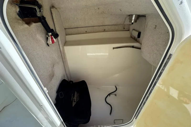 Slide: The Image of 2004 Hydra-Sports Lightning 202 DC storage compartment with carpeted interior and equipment. - 11