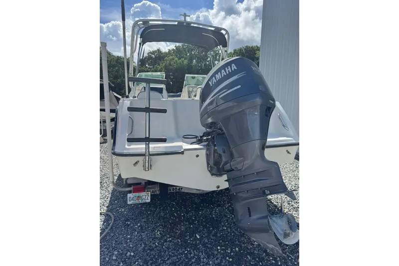 Slide: The Image of 2004 Hydra-Sports Lightning 202 DC boat with Yamaha outboard motor, parked on gravel. - 3