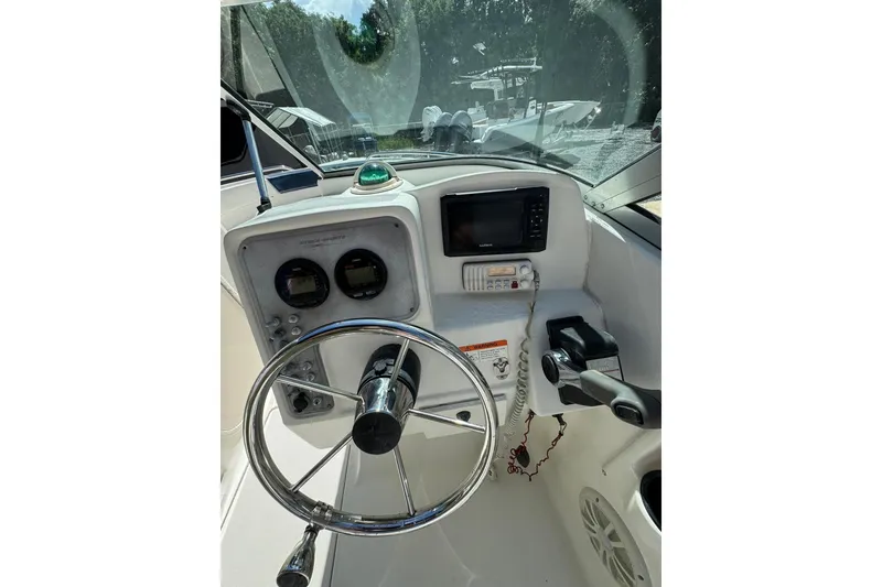 Slide: The Image of 2004 Hydra-Sports Lightning 202 DC boat dashboard with steering wheel and navigation instruments. - 5