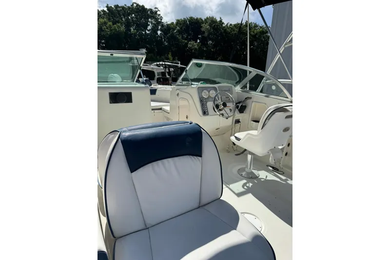 Slide: The Image of 2004 Hydra-Sports Lightning 202 DC boat interior with steering wheel and seating. - 6