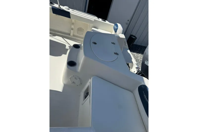 Slide: The Image of 2004 Hydra-Sports Lightning 202 DC boat interior with storage compartments and cup holders. - 7