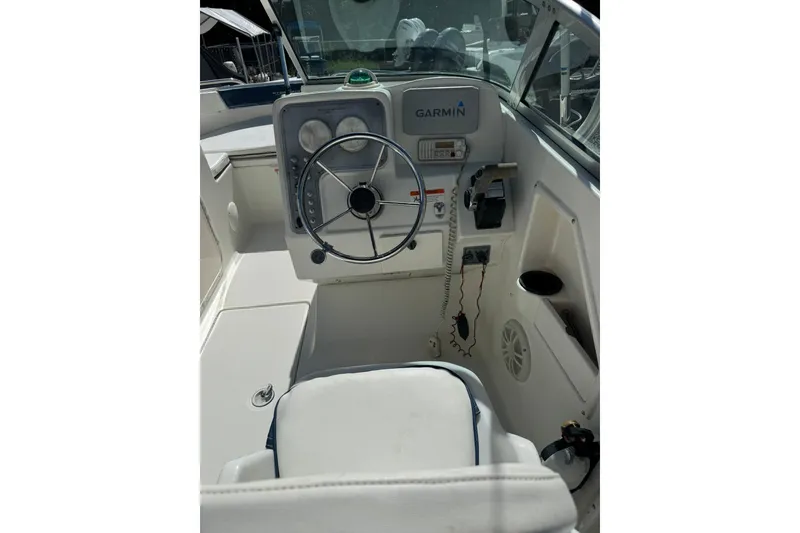 Slide: The Image of 2004 Hydra-Sports Lightning 202 DC boat cockpit with steering wheel and Garmin navigation system. - 8