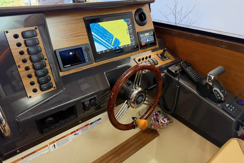 Slide: The Image of 2025 Ranger Tugs R-27 helm with modern navigation and control systems. - 12