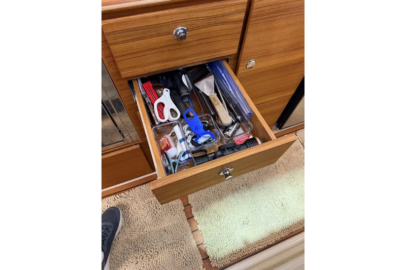 Slide: The Image of Open drawer with tools and accessories in 2025 Ranger Tugs R-27 boat interior. - 13