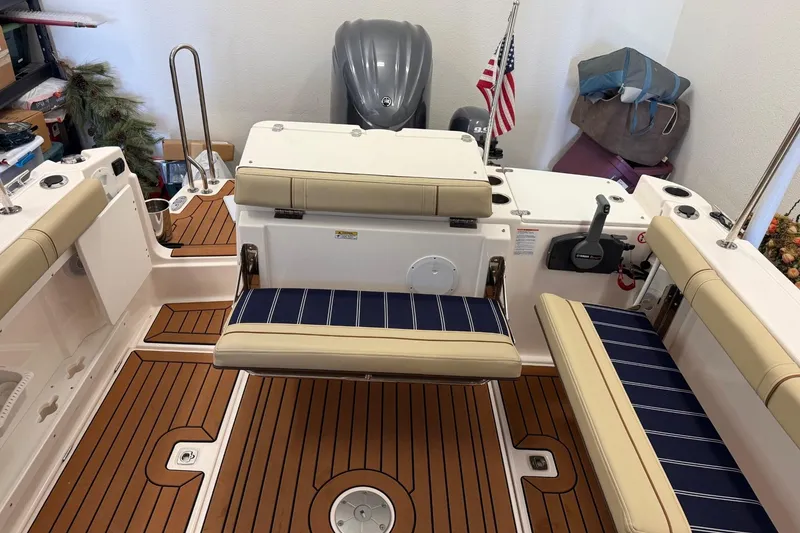 Slide: The Image of 2025 Ranger Tugs R-27 boat interior with seating and American flag. - 17