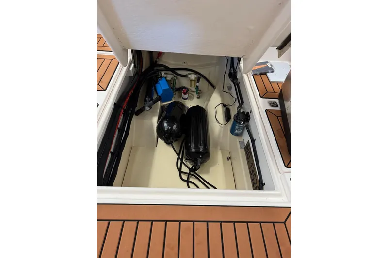 Slide: The Image of Engine compartment of 2025 Ranger Tugs R-27 boat, showcasing mechanical components and wiring. - 19