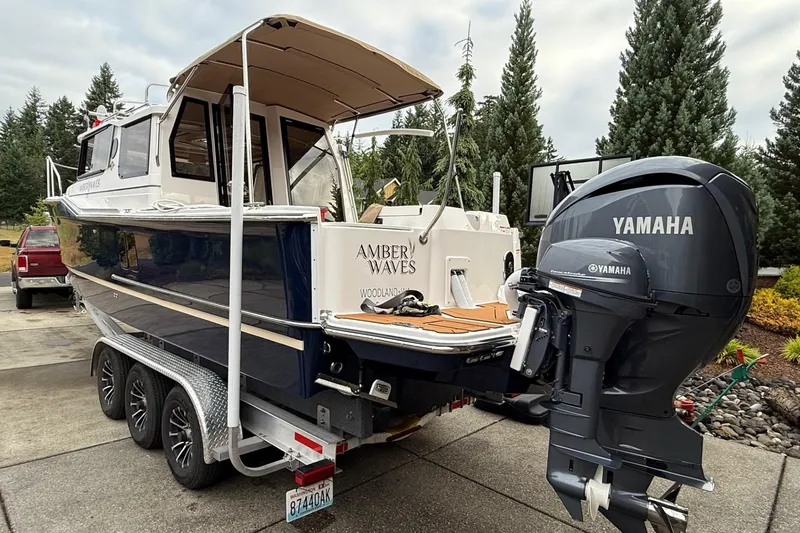 Slide: The Image of 2025 Ranger Tugs R-27 boat with Yamaha outboard motor on trailer. - 5