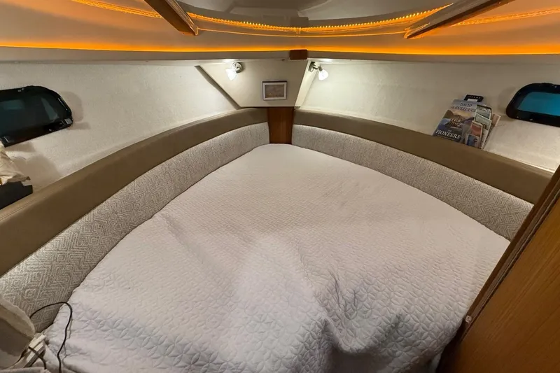 Slide: The Image of Cozy cabin interior of 2025 Ranger Tugs R-27 with ambient lighting and comfortable bedding. - 9