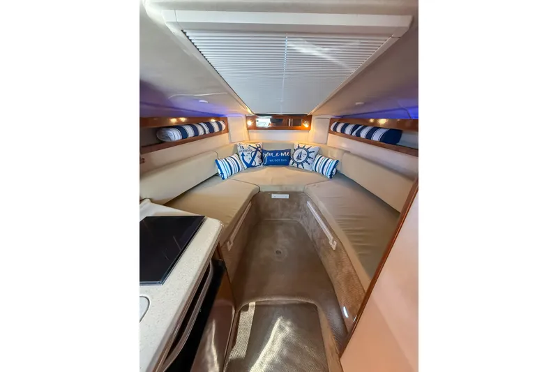 Slide: The Image of Interior of 2009 Sea Ray 270 Sundancer boat with cozy seating and nautical decor. - 11