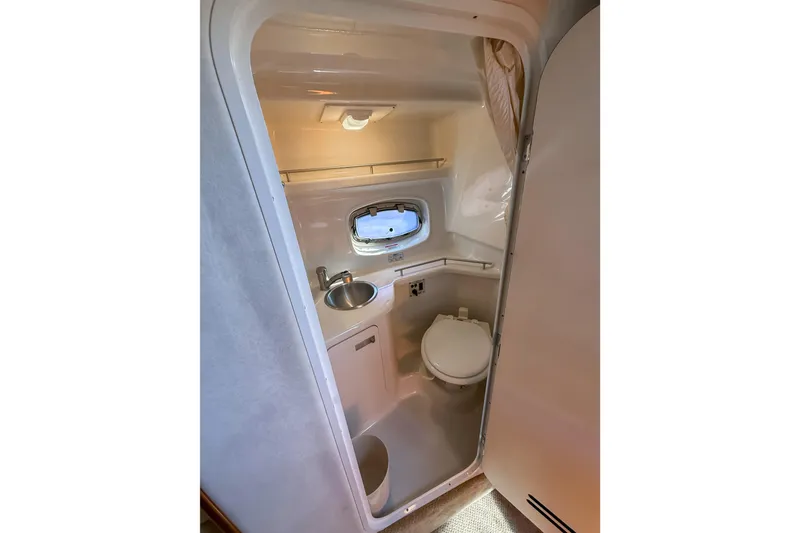Slide: The Image of Compact bathroom in 2009 Sea Ray 270 Sundancer boat with sink and toilet. - 14