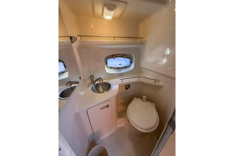 Slide: The Image of Compact bathroom in 2009 Sea Ray 270 Sundancer boat with sink and toilet. - 15