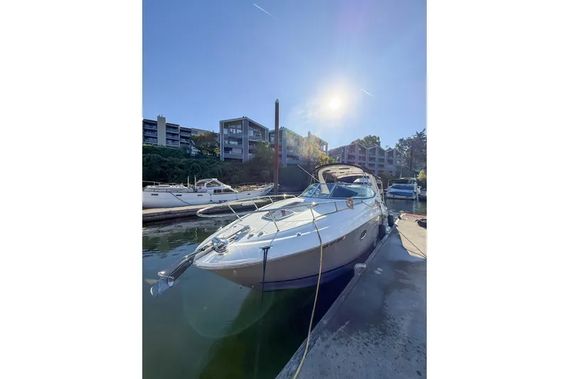 Slide: The Image of 2009 Sea Ray 270 Sundancer docked in a sunny marina setting. - 16