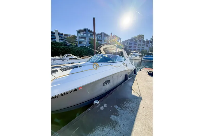 Slide: The Image of 2009 Sea Ray 270 Sundancer docked at marina under bright sun. - 17