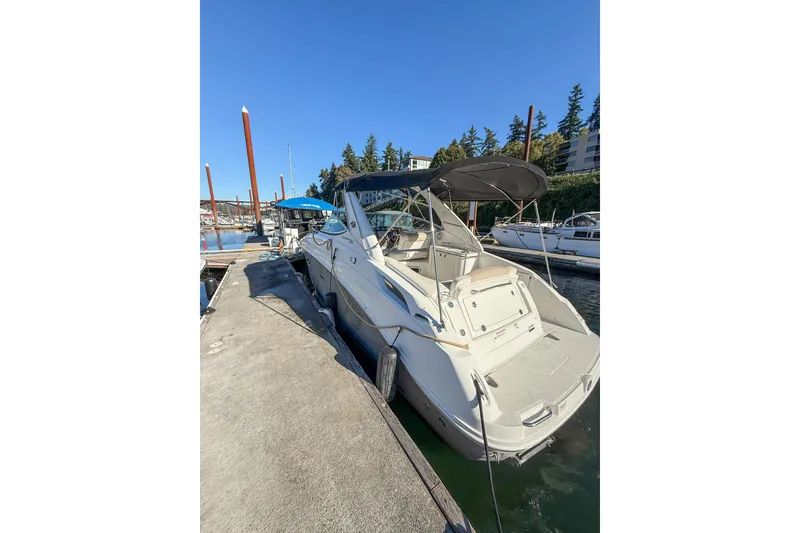 Slide: The Image of 2009 Sea Ray 270 Sundancer docked at marina under clear blue sky. - 18
