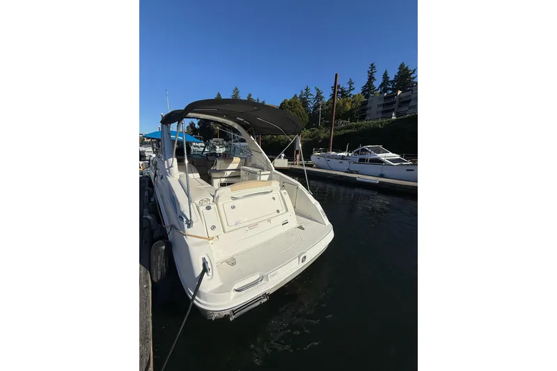 Slide: The Image of 2009 Sea Ray 270 Sundancer docked at marina under clear blue sky. - 2