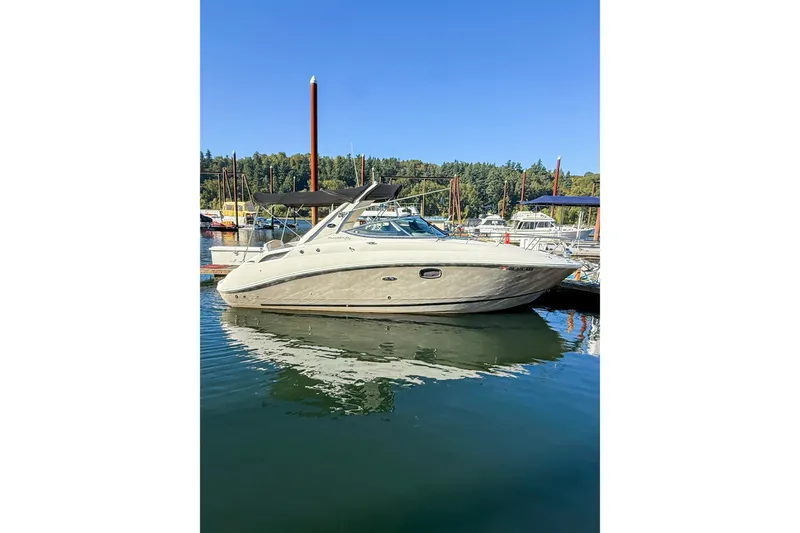 Slide: The Image of 2009 Sea Ray 270 Sundancer boat docked in a marina under clear blue skies. - 20