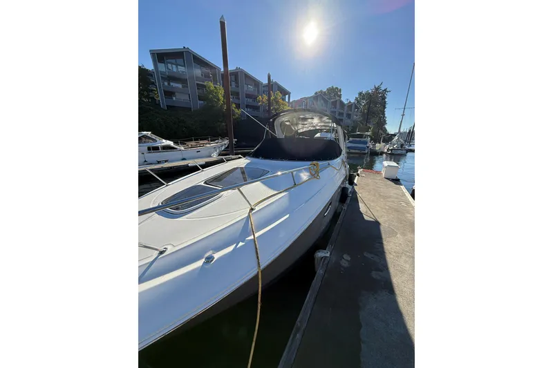 Slide: The Image of 2009 Sea Ray 270 Sundancer docked under sunny skies at marina. - 23