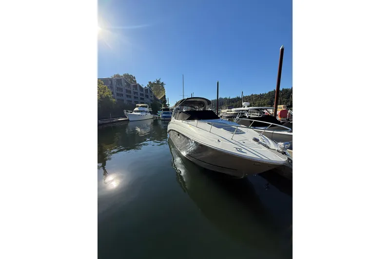 Slide: The Image of 2009 Sea Ray 270 Sundancer docked in a sunny marina setting. - 25