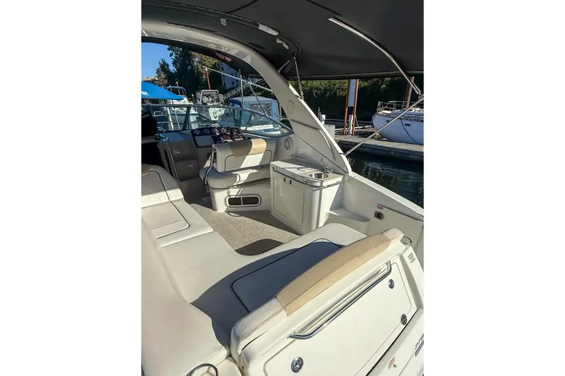 Slide: The Image of 2009 Sea Ray 270 Sundancer interior with seating and helm, docked at marina. - 3
