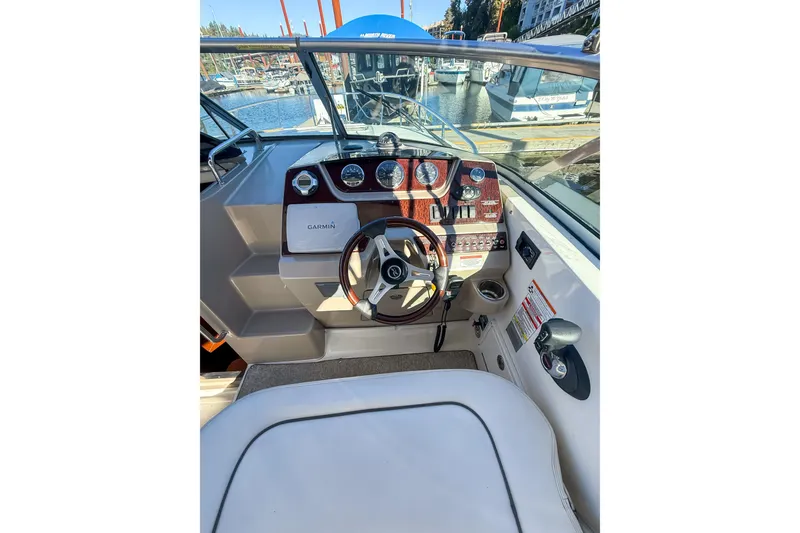 Slide: The Image of 2009 Sea Ray 270 Sundancer helm with Garmin navigation, docked at marina. - 6