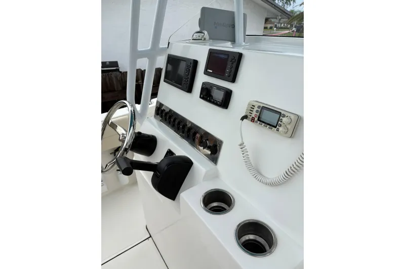 Slide: The Image of 2019 Release 210 RX boat console with steering wheel, controls, and electronic displays. - 11