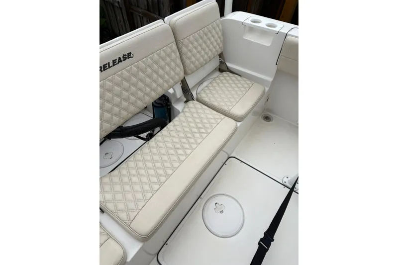 Slide: The Image of 2019 Release 210 RX boat interior with quilted beige seating and cup holders. - 12