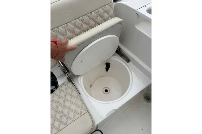 Slide: The Image of 2019 Release 210 RX boat seat with storage compartment open. - 16