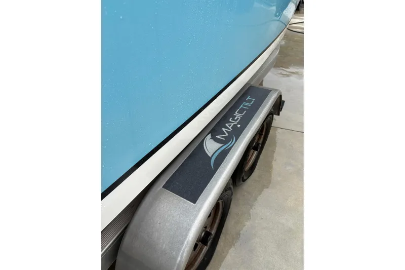Slide: The Image of Blue 2019 Release 210 RX boat on Magic Tilt trailer, wet surface. - 19