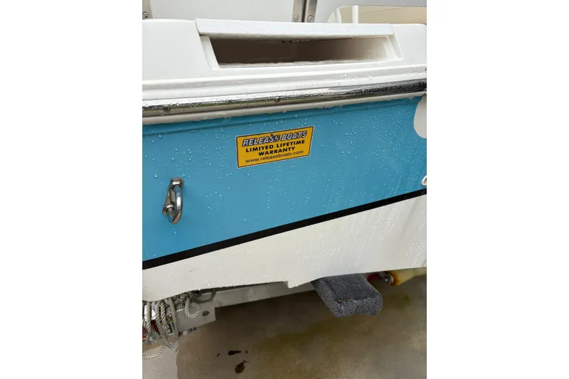 Slide: The Image of 2019 Release 210 RX boat with warranty sticker, wet exterior detail. - 21