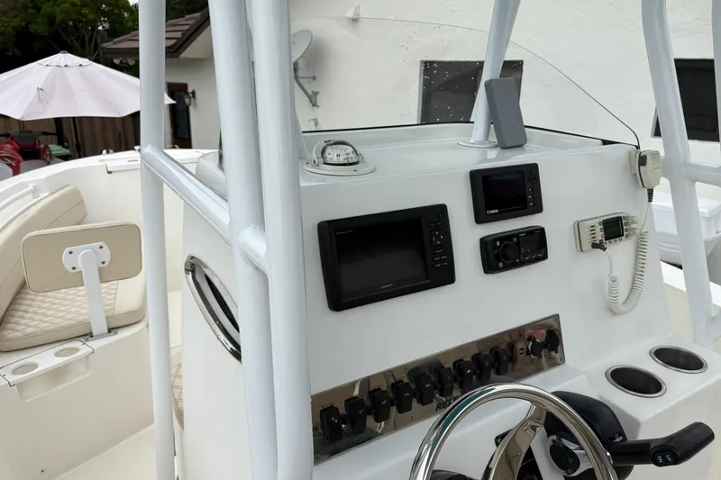 Slide: The Image of 2019 Release 210 RX boat console with navigation instruments and steering wheel. - 23
