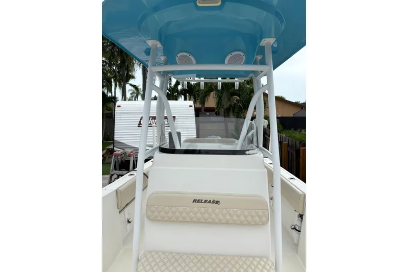 Slide: The Image of 2019 Release 210 RX boat with blue canopy and beige seating. - 4