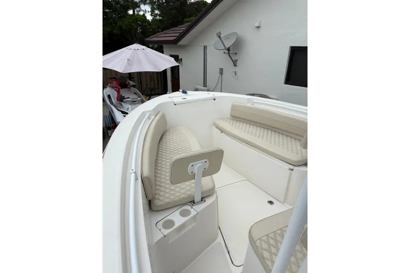 Slide: The Image of 2019 Release 210 RX boat interior with beige seating and cup holders. - 6