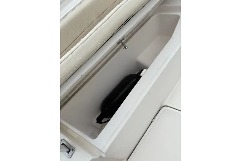 Slide: The Image of Storage compartment of 2019 Release 210 RX boat with black bag inside. - 7