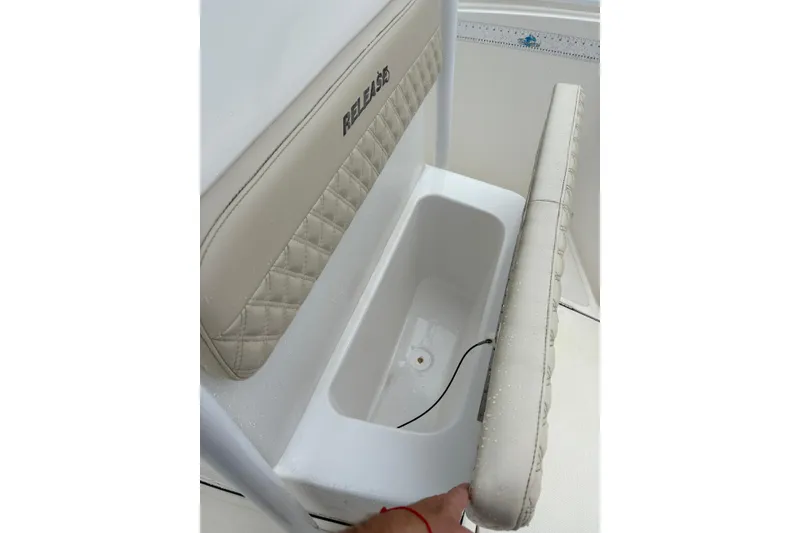 Slide: The Image of 2019 Release 210 RX boat seat with storage compartment open. - 9