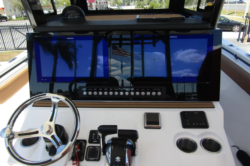 Slide: The Image of 2025 Sea Pro 322 Offshore boat dashboard with steering wheel and navigation screens. - 23