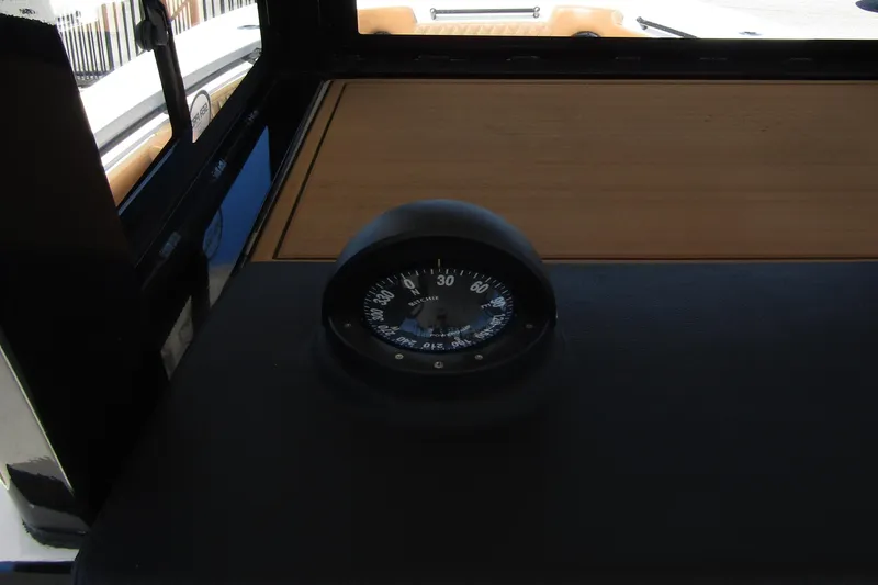 Slide: The Image of Compass on the dashboard of a 2025 Sea Pro 322 Offshore boat. - 24