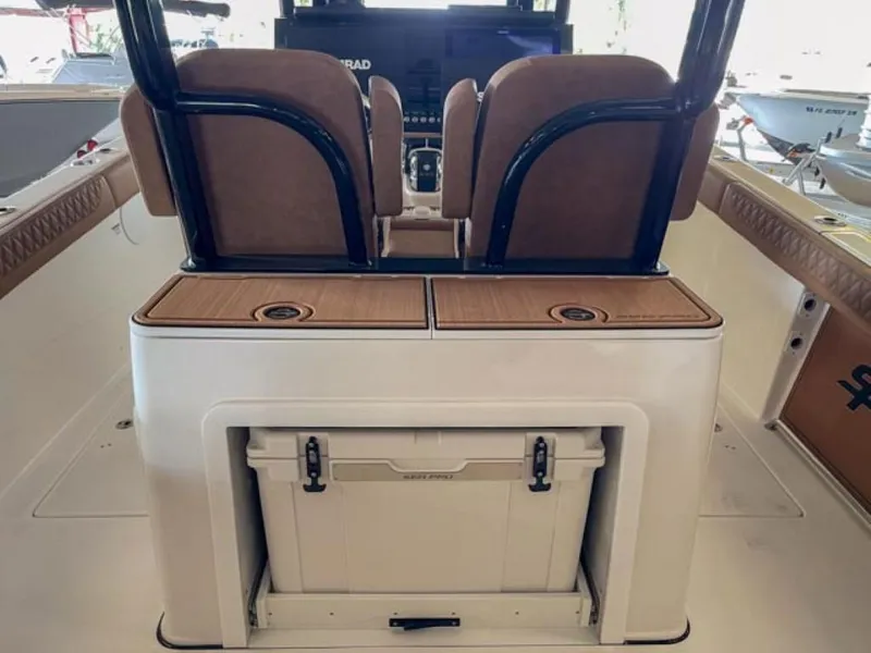 Slide: The Image of 2025 Sea Pro 322 Offshore boat interior with brown cushioned seating and white deck. - 6