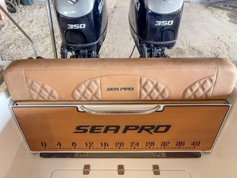 Slide: The Image of 2025 Sea Pro 322 Offshore boat interior with brown cushioned seating and table. - 9