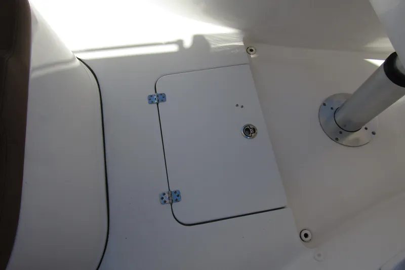 Slide: The Image of 2025 Sea Pro 322 Offshore boat interior with storage hatch and metal support pole. - 15