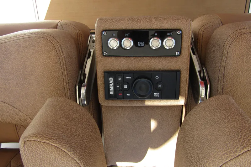Slide: The Image of 2025 Sea Pro 322 Offshore boat seat controls and Simrad navigation system. - 29