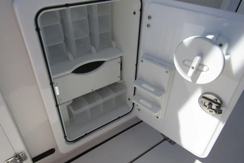 Slide: The Image of Open storage compartment on 2025 Sea Pro 322 Offshore boat, featuring organized shelves and secure latch. - 32